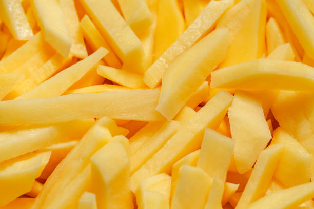 istock Potatoes, cut into strips, preparation for frying fries, close-up, selective focus 1441213621
