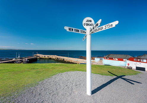 Famous multi-directional landmark and tourist destination,in hot sun,on north coast 500 route.Furthest northerly point of mainland Britain,famous for charity runs,to and from Land's End in Cornwall.