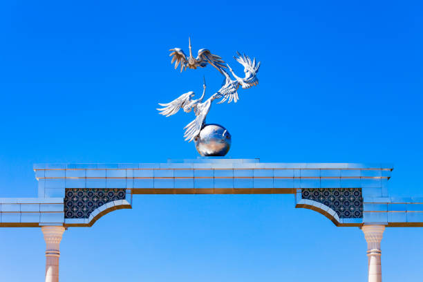 Tashkent, Uzbekistan - April 11, 2021: Storks flying over the globe in the Ezgulik Arch of Good and Noble Aspirations at Independence square, Tashkent city in Uzbekistan