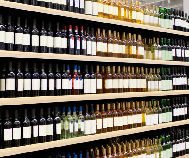 Wine bottles on shelf close up Wine bottles on shelf. Red and White vine bottles on shelves in supermarket interior. 
3D rendering Suitable for presenting new Vine bottles and new brand label among many others. rose champagne stock pictures, royalty-free photos & images