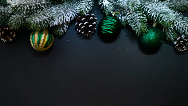 istock Christmas composition. Fir branches, balls and cones on a black background 1441217583