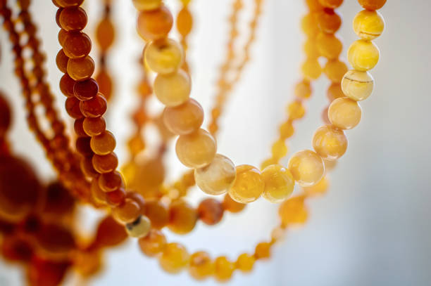 Various amber beads on a  bright background Various amber beads on a  bright background. Close up. bijou personal accessory stock pictures, royalty-free photos & images