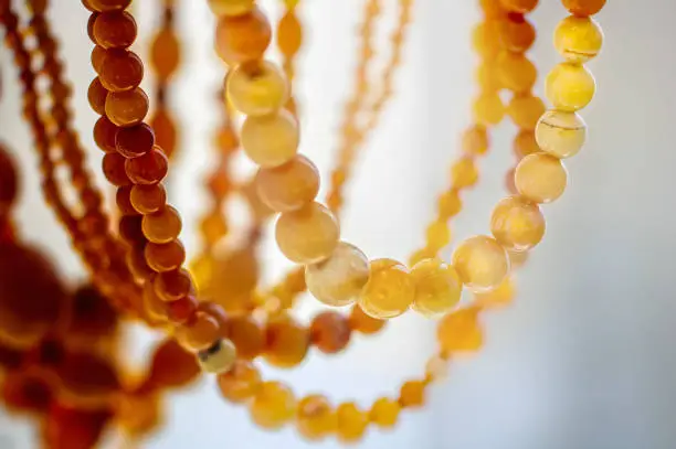 Photo of Various amber beads on a  bright background