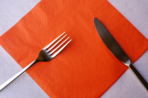 Knife and Fork on Red Napkin.