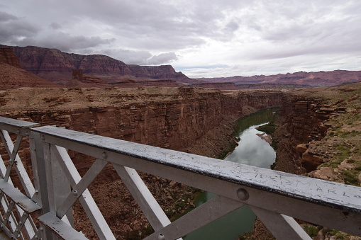 Historic navajo bridge over the Colorado river in Arizona with thunder storm clouds coming in