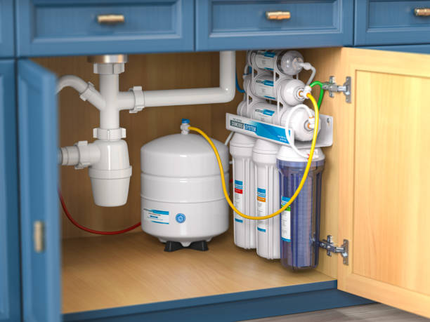 Reverse osmosis water purification system under sink in a kitchen.  Water cleaning system installation. stock photo