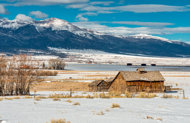 istock Weathered Cabins Set Against Winter Mountains 1441225898