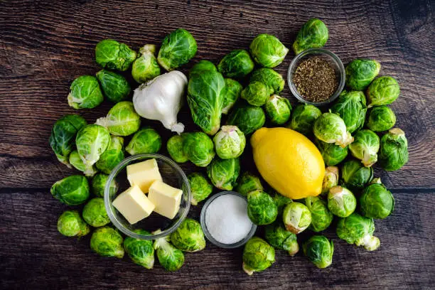 Raw Brussels sprouts, garlic, and other ingredients for a side dish