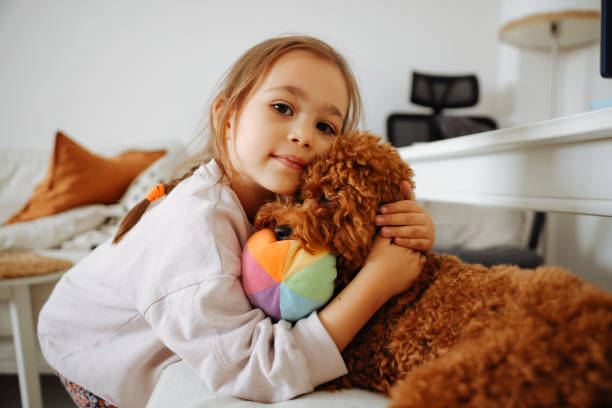 istock Little girl playing with dog 1441230802