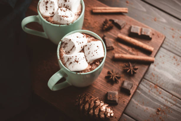 istock Hot chocolate drink with marshmallow in a cup on wooden board, dark background 1441231154