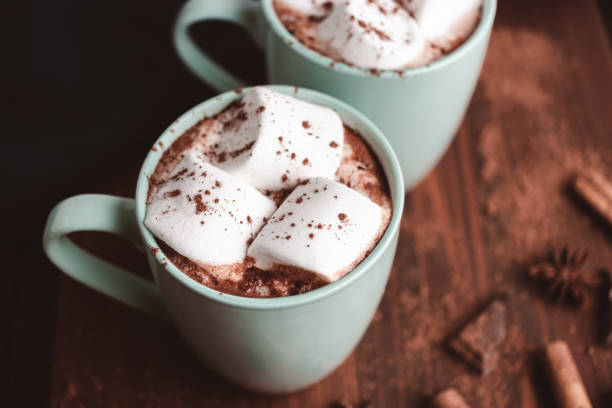 istock Hot chocolate drink with marshmallow in a cup on wooden board, dark background 1441231244