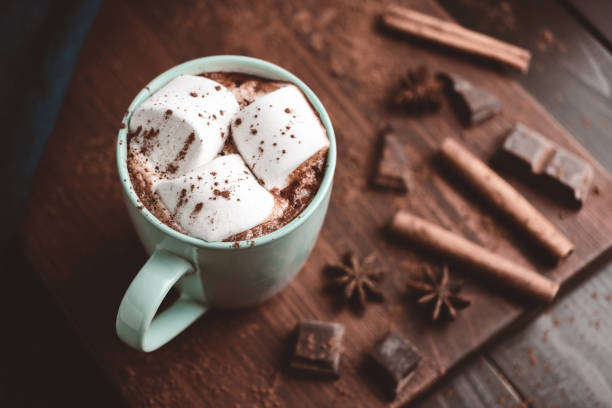 istock Hot chocolate drink with marshmallow in a cup on wooden board, dark background 1441231287