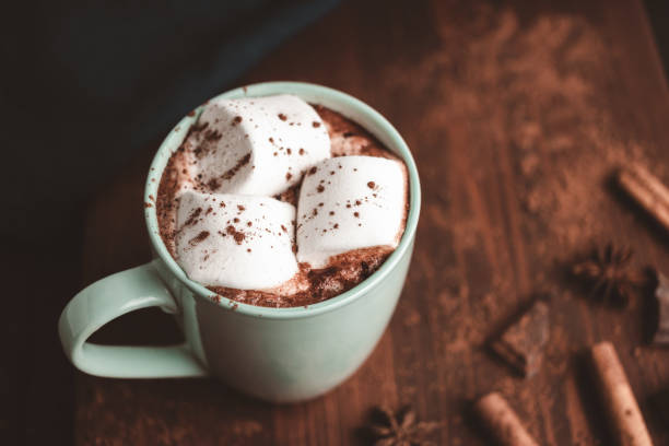 istock Hot chocolate drink with marshmallow in a cup on wooden board, dark background 1441231288