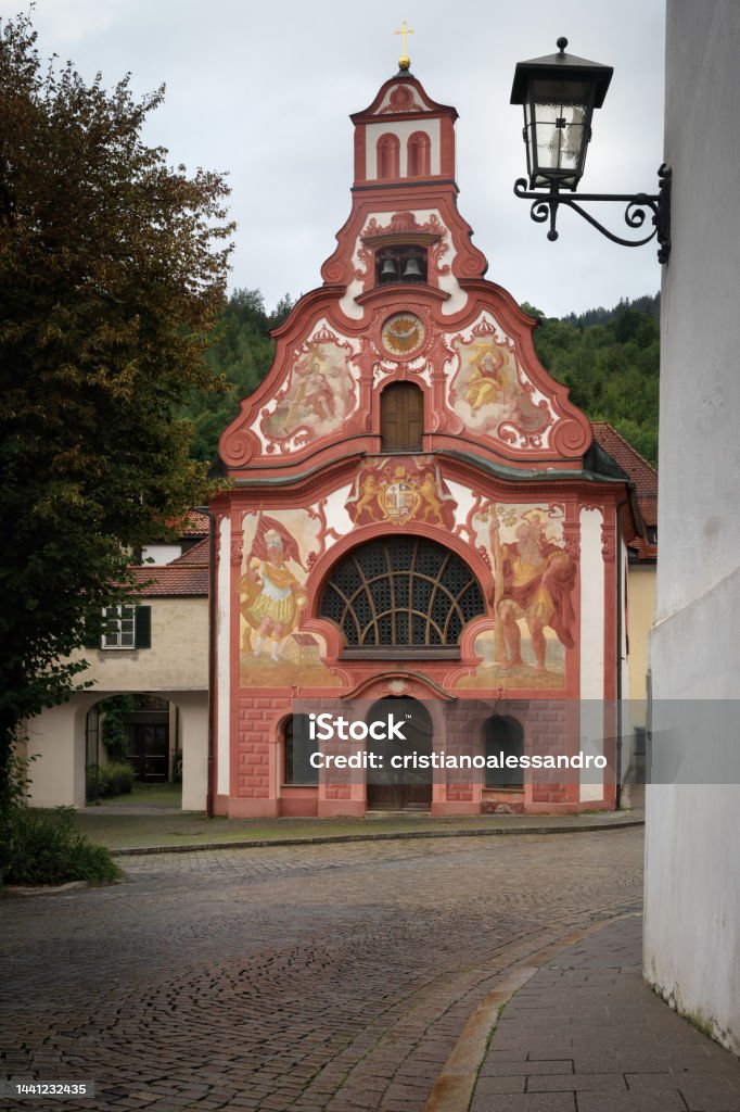 View of the traditional painted bavarian church of the holy spirit in the village of Fussen View of the traditional painted bavarian church of the holy spirit in the village of Fussen, famous travel destination on the Romanic Road of Bavaria, Germany Architecture Stock Photo
