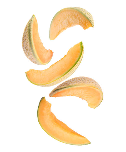 istock Pieces of delicious ripe melon falling on white background 1441232824
