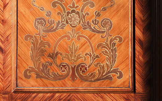 Decorative inlay carving pattern of vintage wooden wall panel, close up