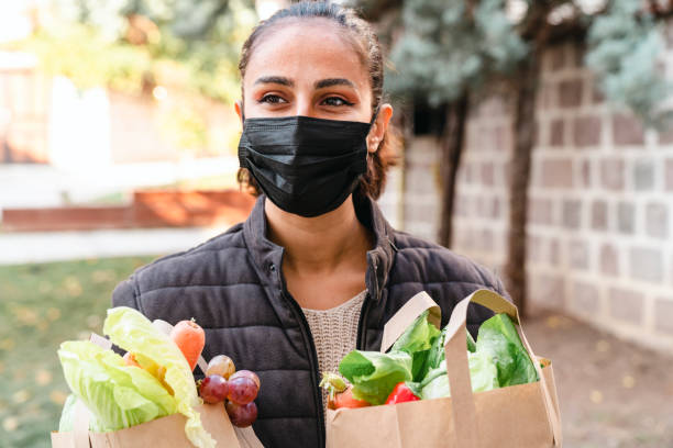 istock Volunteer Delivering Food To Elderly People During Lockdown 1441234769