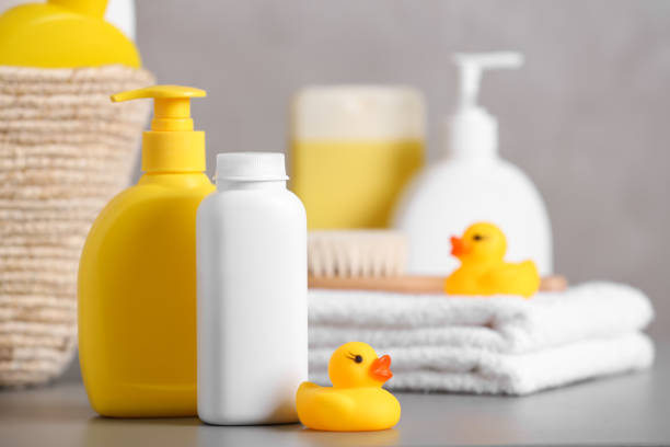 istock Baby cosmetic products, towel and rubber ducks on grey table, space for text 1441236122