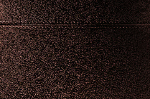 Close-up of a black briefcase (faux leather texture). Space for copy.