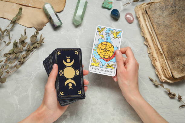 istock Woman with tarot cards at grey table, closeup 1441237539