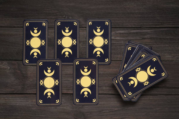 istock Tarot cards on black wooden table, flat lay. Reverse side 1441238286