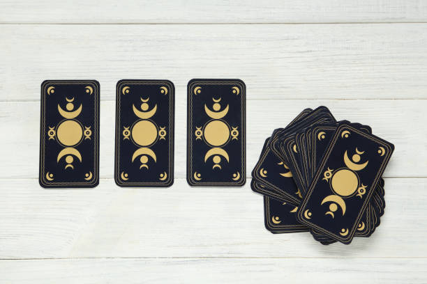 istock Tarot cards on white wooden table, flat lay. Reverse side 1441238307