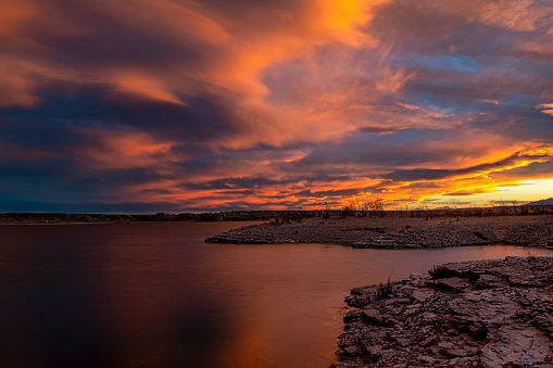 Photograph of the sky just lightening up with the most beautiful colors after the sun has set behind the mountains west of Pueblo, Colorado while viewing from the shores of Pueblo Reservoir.