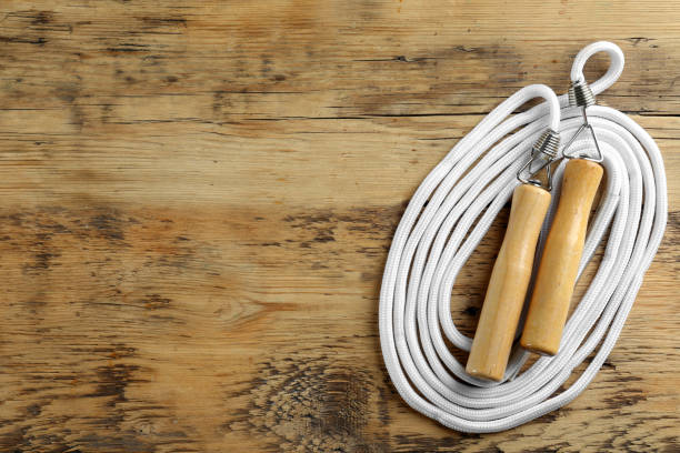 istock Skipping rope on wooden table, top view. Space for text 1441238685