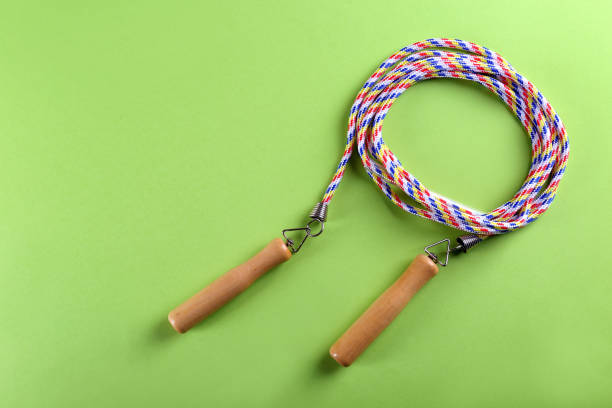 istock Skipping rope on green background, top view. Space for text 1441238761