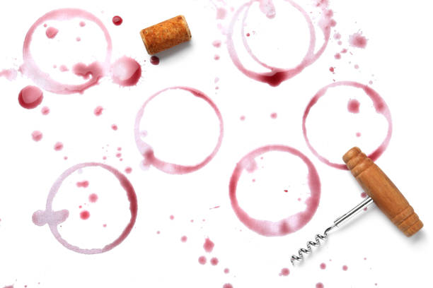 istock Red wine rings, drops, bung and corkscrew on white background, top view 1441240075