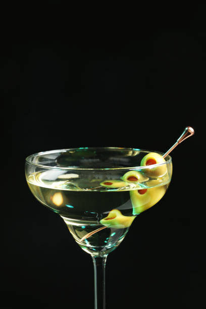 istock Martini cocktail with olives on dark background, closeup. Space for text 1441240883