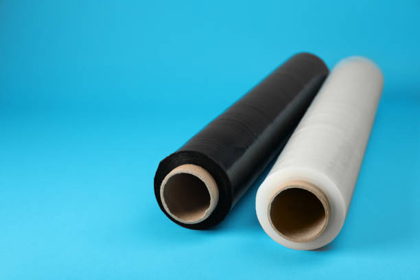 istock Rolls of different stretch wrap on turquoise background. Space for text 1441245405