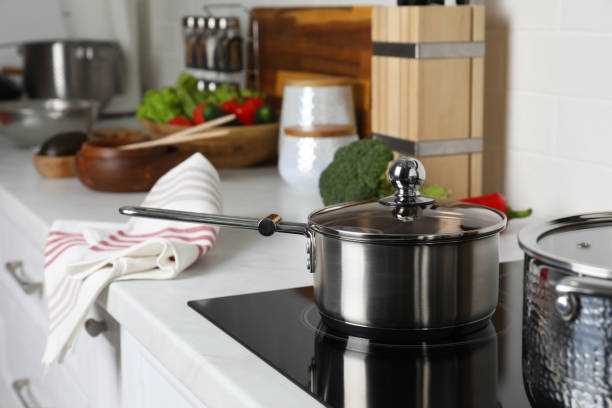 istock Metal saucepan on cooktop in kitchen. Cooking utensils 1441245797