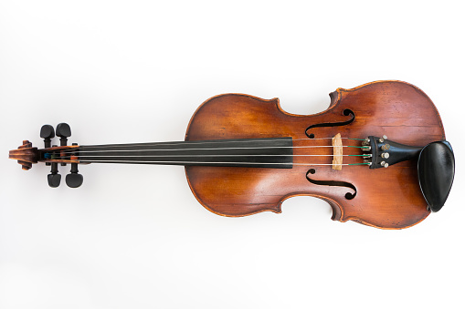 Close-up of violin detail on black background with copy space.