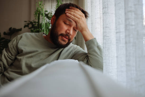 istock Man sitting alone at home looking sad and distraught 1441246344