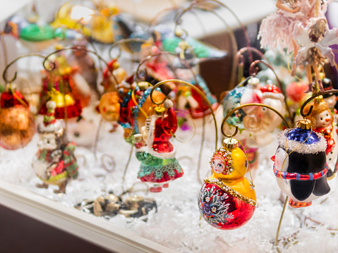 Moscow, Russia - December 19, 2021. Sale of retro decorations for Christmas tree in souvenir shop. Traditional vintage toy matryoshka for New Year celebration.