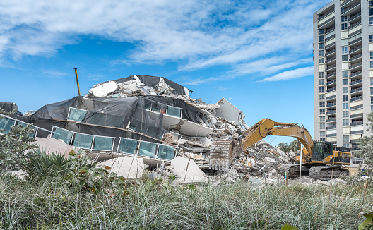 Miami Beach, United States - November 13, 2022: Excavators quickly remove debris from the imploded demolition of Miami Beach's famed Deauville Beach Resort hotel. In this hotel, built in 1957, the Beatles performed in 1964 and they had US presidents such as JFK and Ronald Reagan as guests.