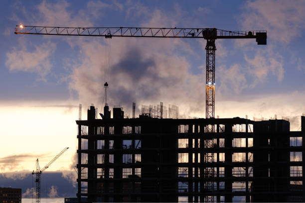 istock Tower crane, workers work at construction site. Process of building new houses 1441247492