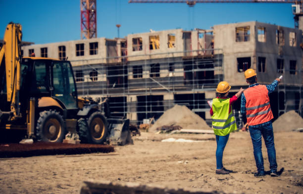 istock Supervisor and site manager discussing multi story building project 1441250646
