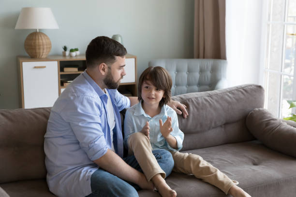 istock Loving dad listen with interest his little son 1441251656