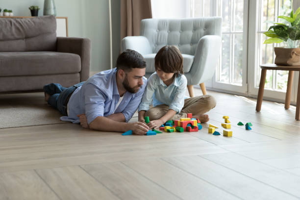 istock Dad and son play wooden bricks at home 1441251663