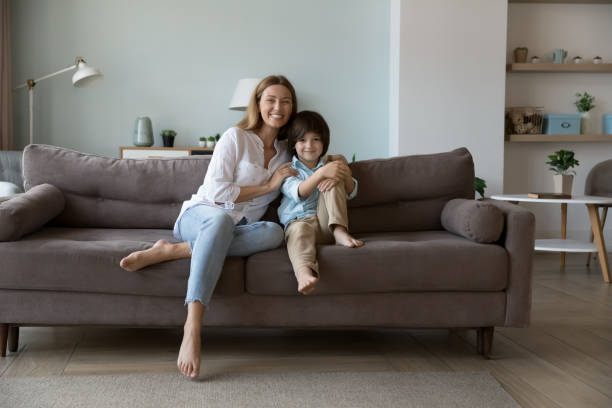 istock Young beautiful mother hugs little son posing together on camera 1441252158