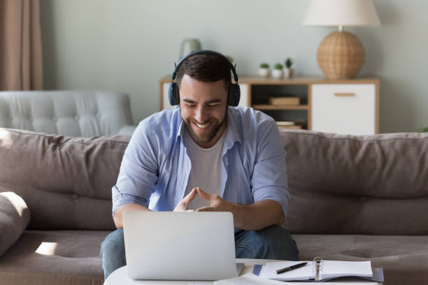 istock Smiling man take part in video call at home 1441252998