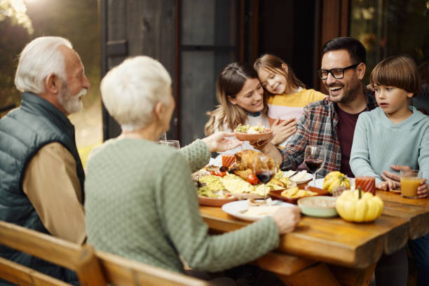 istock Happy extended family having lunch on a terrace. 1441253792