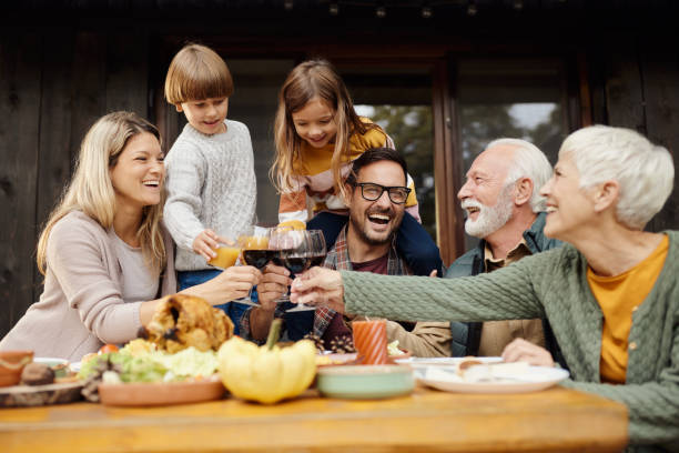 istock Happy multi-generation family toasting during lunch on a patio. 1441253929