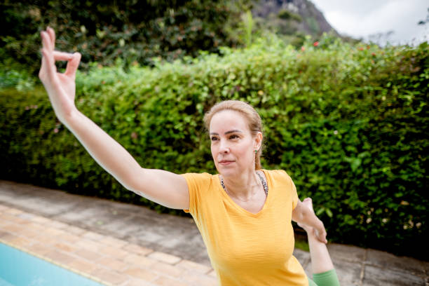 istock Woman practicing yoga in the garden 1441255157