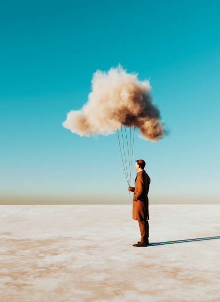 istock Man holds on to a cloud like it was a balloon 1441257702
