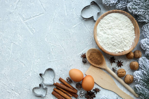 Ingredients for cooking christmas baking. Flour, eggs, brown sugar and spices. Top view with copy space stock photo