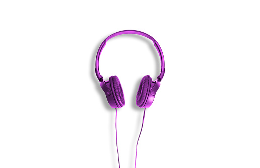Violet headphones on a white background. The concept of listening to music, creating audio, music. Computer work, abstraction and minimalist style.