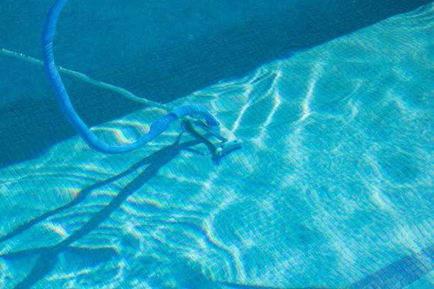 istock A manual pool cleaner under the waters of the blue tile pool. 1441263410